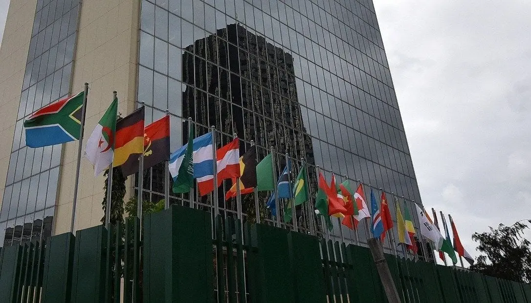 National flags flying outside a modern African office building